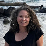 Woman on beach shore smiling