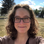 Woman with curly hair and glasses