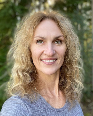 Woman with curly blonde hair smiling