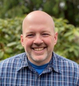 Man in blue shirt smiling