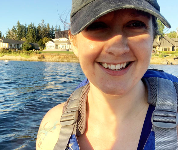 Girl wearing ball cap and smiling