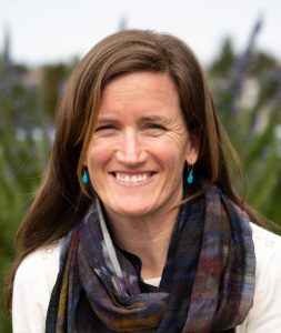 woman with long brown hair smiling