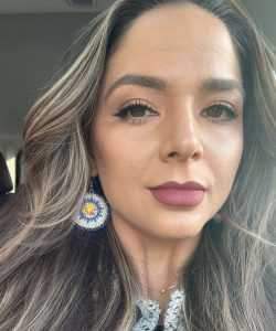 A woman with long hair looking at camera