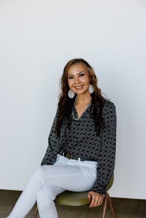 A woman with shoulder length hair smiling at camera